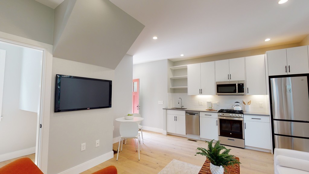 48 St John Street Boston, MA 02130 - Photo 16 of 25 a kitchen with stainless steel appliances a refrigerator stove microwave and cabinets