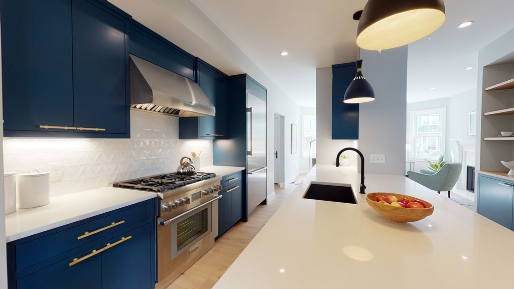 48 St John Street Boston, MA 02130 - Photo 3 of 25 a kitchen with stainless steel appliances a stove a sink dishwasher and cabinets with wooden floor