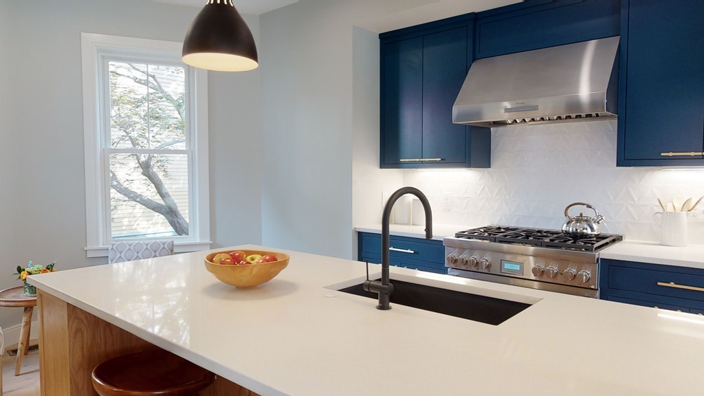 48 St John Street Boston, MA 02130 - Photo 4 of 25 a kitchen with stainless steel appliances a sink a stove and a wooden cabinets
