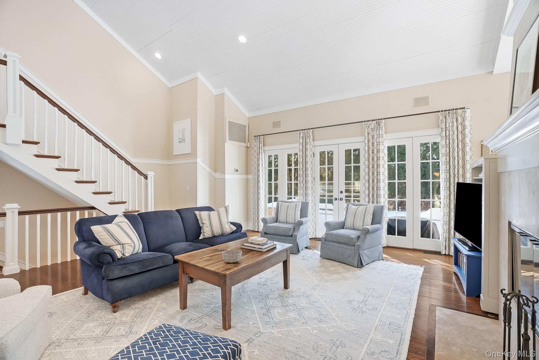 880 Forest Avenue Rye, NY 10580 - Photo 17 of 48 a living room with furniture a flat screen tv and a fireplace