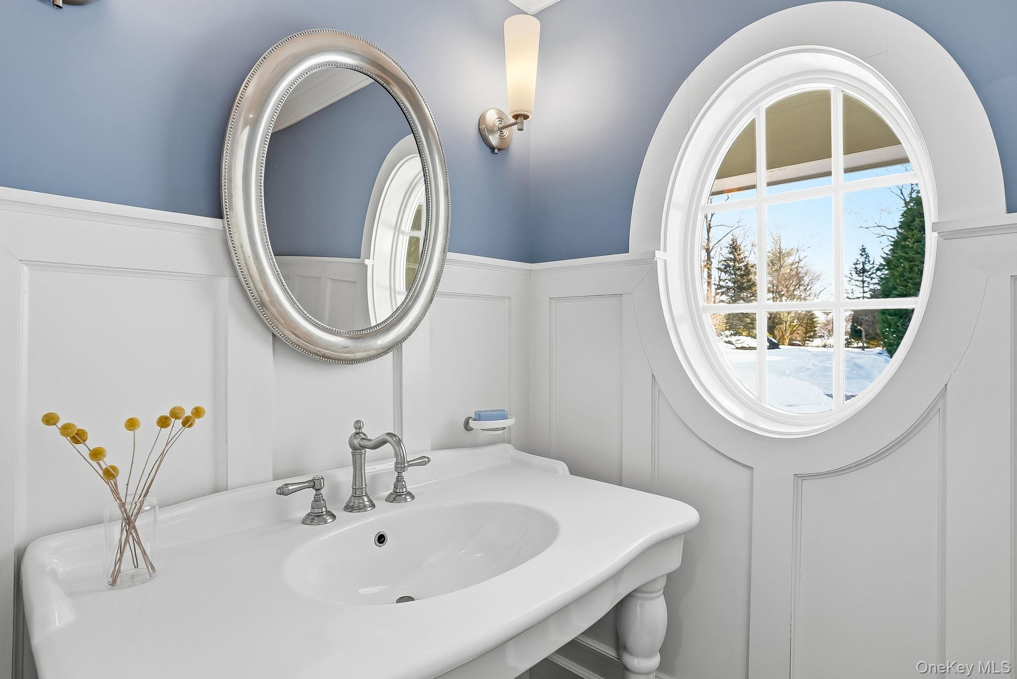 880 Forest Avenue Rye, NY 10580 - Photo 19 of 48 a bathroom with a sink and a mirror