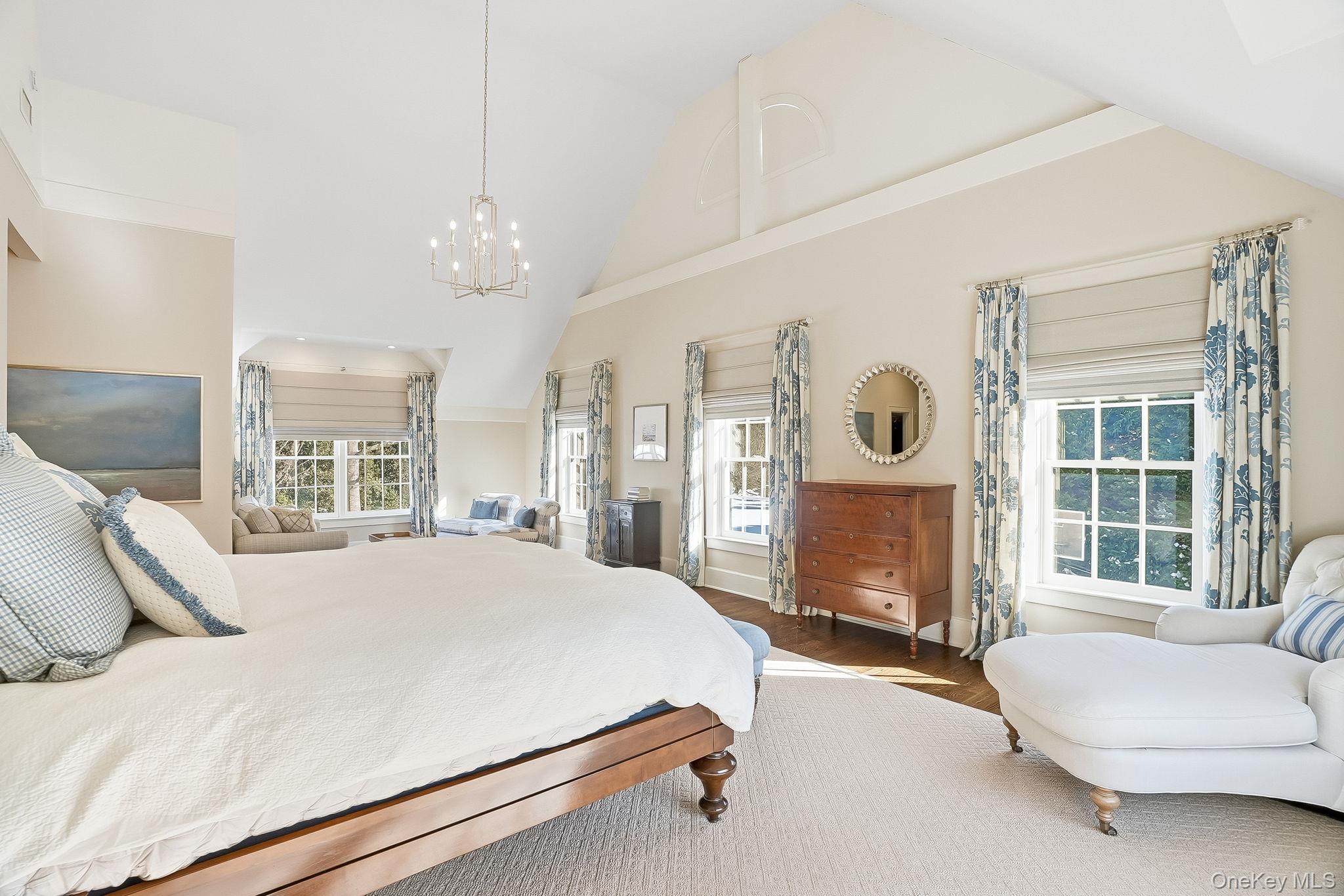 880 Forest Avenue Rye, NY 10580 - Photo 25 of 48 a living room with a bed furniture and a large window