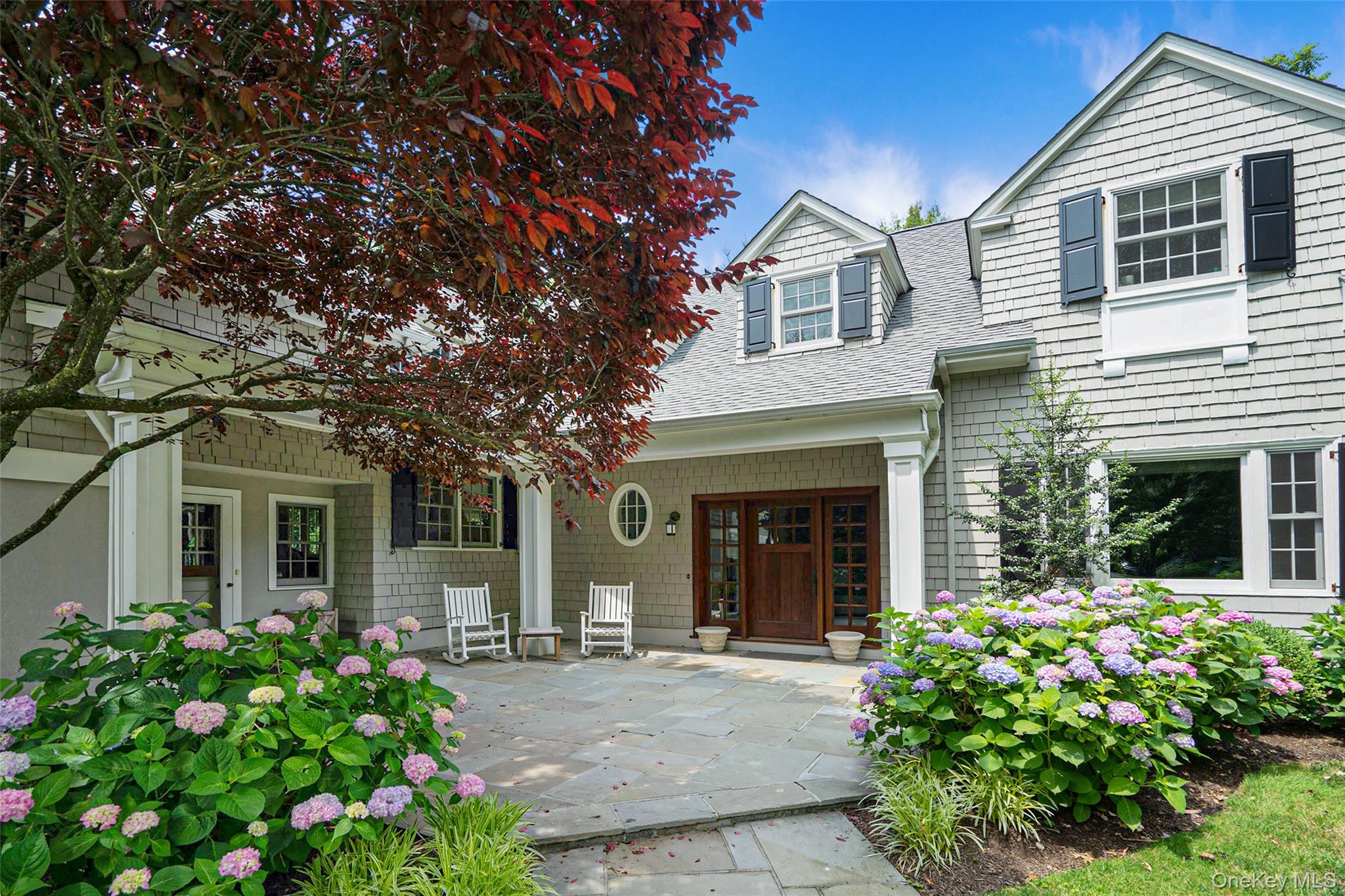 880 Forest Avenue Rye, NY 10580 - Photo 4 of 48 front view of a house with a yard