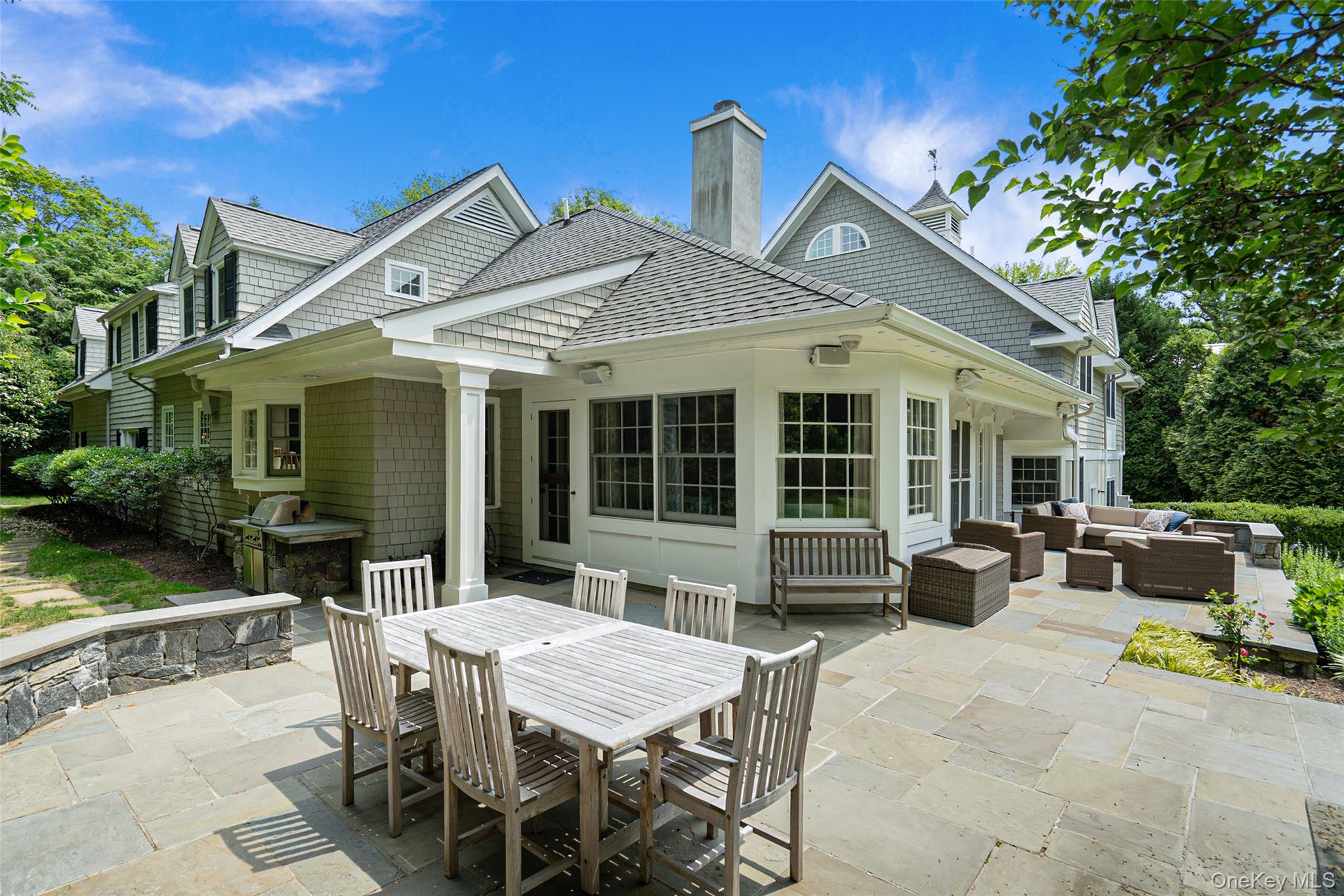 880 Forest Avenue Rye, NY 10580 - Photo 42 of 48 a view of a house with a backyard and sitting area