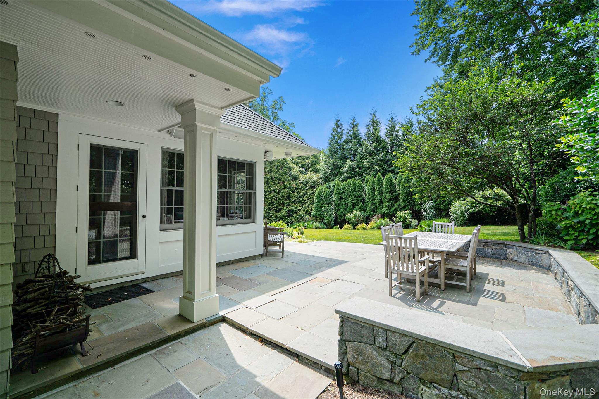 880 Forest Avenue Rye, NY 10580 - Photo 43 of 48 a view of a patio with table and chairs and potted plants