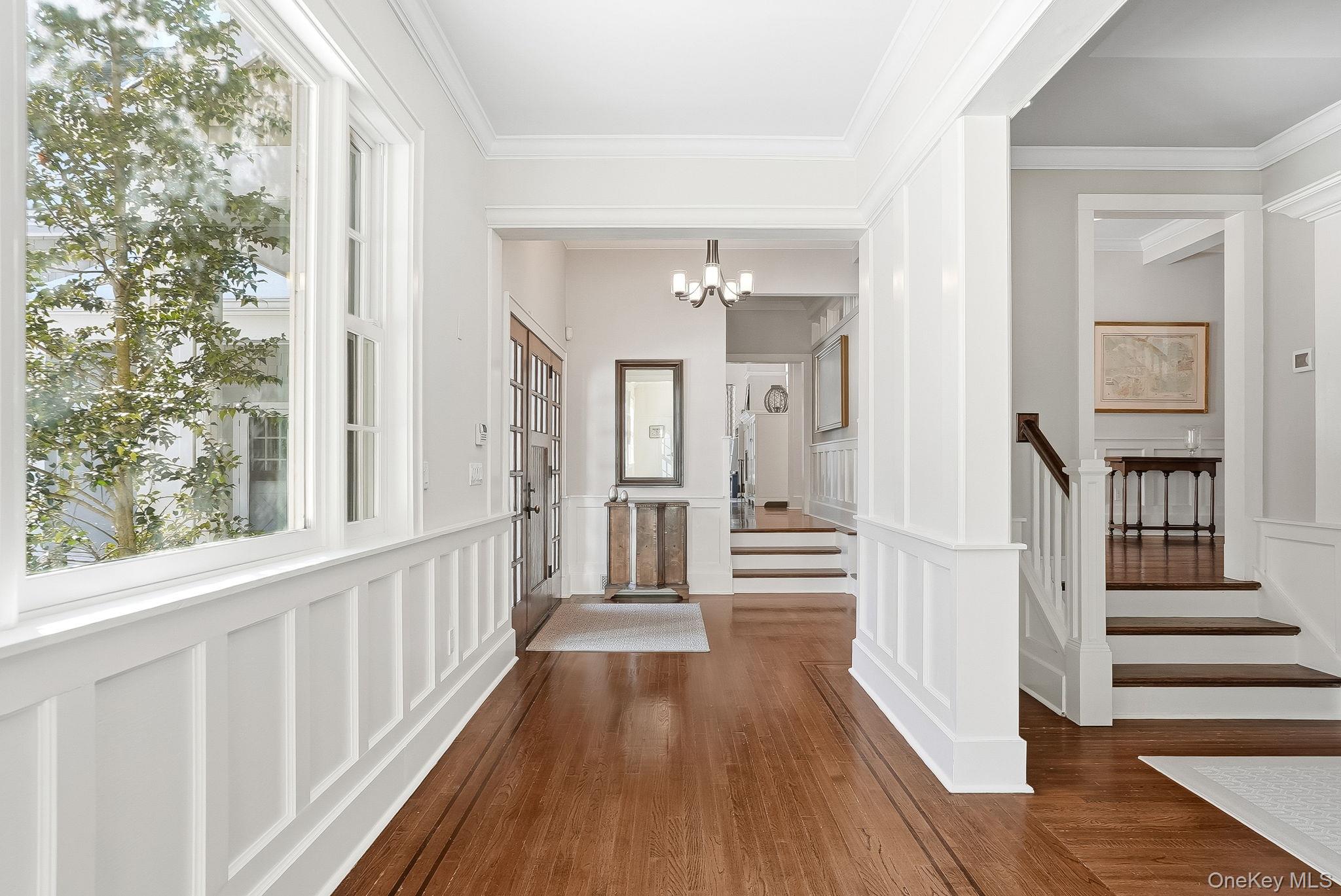 880 Forest Avenue Rye, NY 10580 - Photo 6 of 48 a view of a hallway with wooden floor and windows