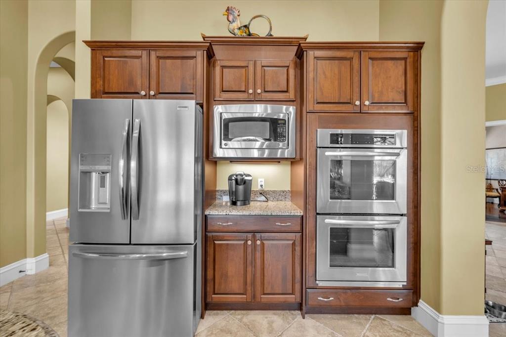 28959 Smugglers Lane Punta Gorda, FL 33982 - Photo 12 of 45 a kitchen with stainless steel appliances granite countertop a refrigerator and microwave