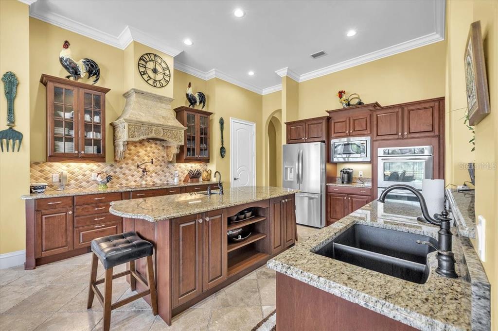 28959 Smugglers Lane Punta Gorda, FL 33982 - Photo 13 of 45 a kitchen with stainless steel appliances granite countertop a sink and cabinets
