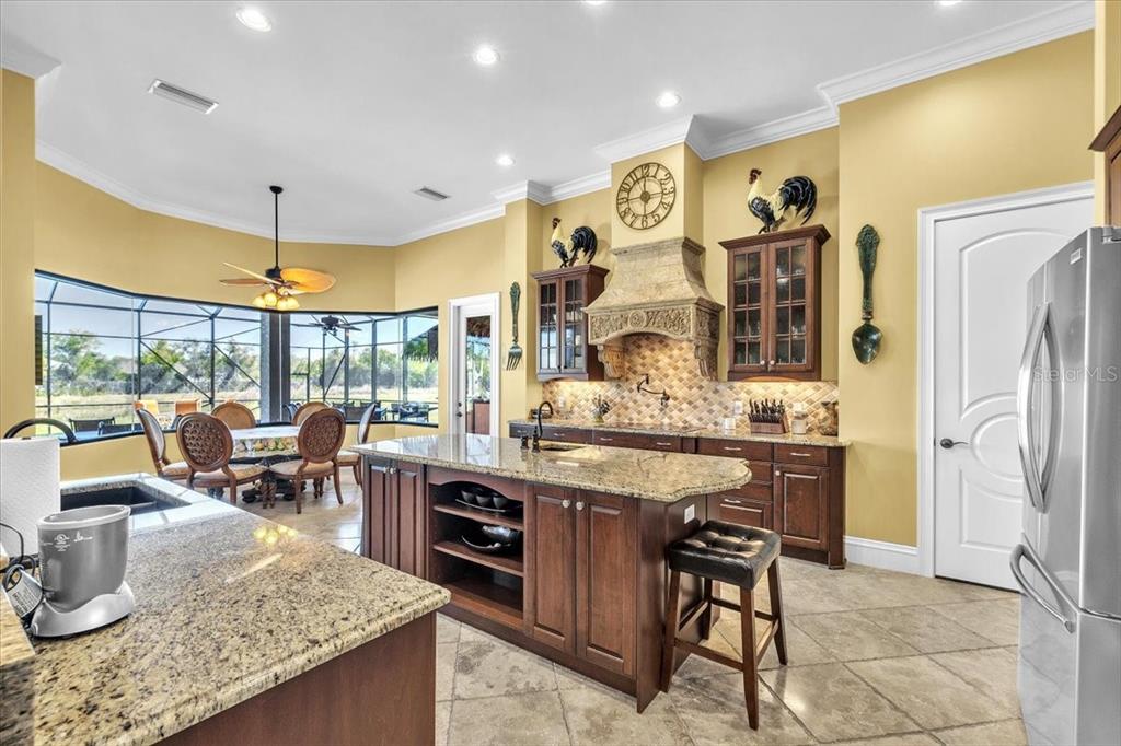 28959 Smugglers Lane Punta Gorda, FL 33982 - Photo 15 of 45 a open kitchen with stainless steel appliances granite countertop a stove and refrigerator
