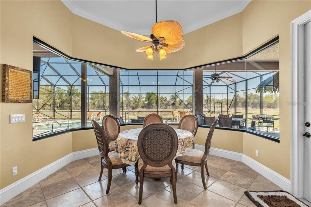 28959 Smugglers Lane Punta Gorda, FL 33982 - Photo 16 of 45 a dining room with furniture a chandelier and wooden floor