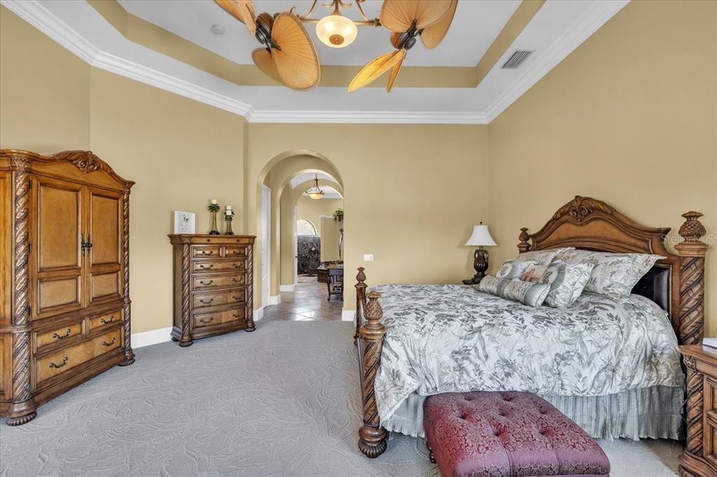 28959 Smugglers Lane Punta Gorda, FL 33982 - Photo 18 of 45 a bedroom with a bed and a chandelier
