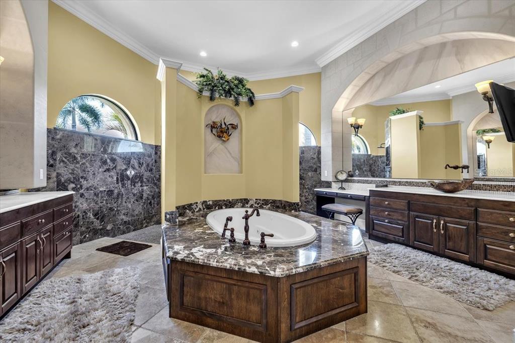 28959 Smugglers Lane Punta Gorda, FL 33982 - Photo 20 of 45 a spacious bathroom with a granite countertop tub double vanity and a sink