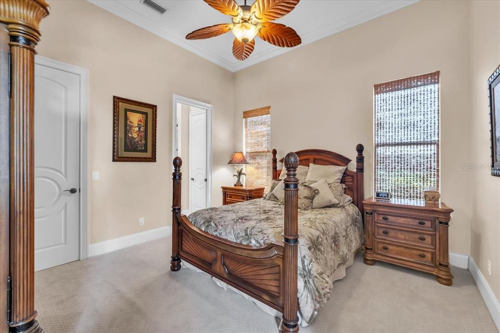 28959 Smugglers Lane Punta Gorda, FL 33982 - Photo 22 of 45 a bedroom with a bed and a chandelier
