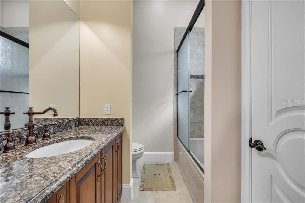 28959 Smugglers Lane Punta Gorda, FL 33982 - Photo 23 of 45 a bathroom with a granite countertop sink and a mirror