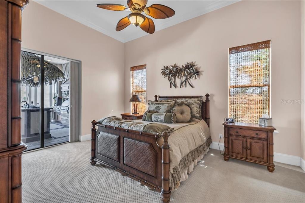28959 Smugglers Lane Punta Gorda, FL 33982 - Photo 24 of 45 a bedroom with a bed and a chandelier