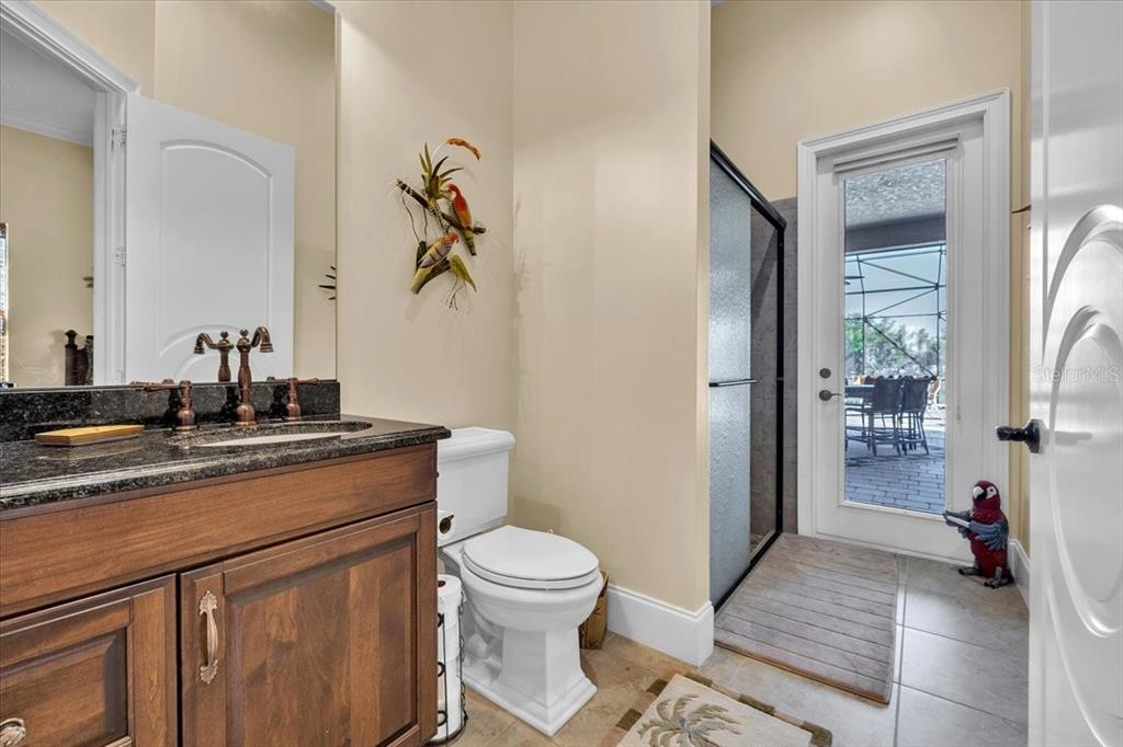 28959 Smugglers Lane Punta Gorda, FL 33982 - Photo 25 of 45 a bathroom with a toilet a sink and glass door