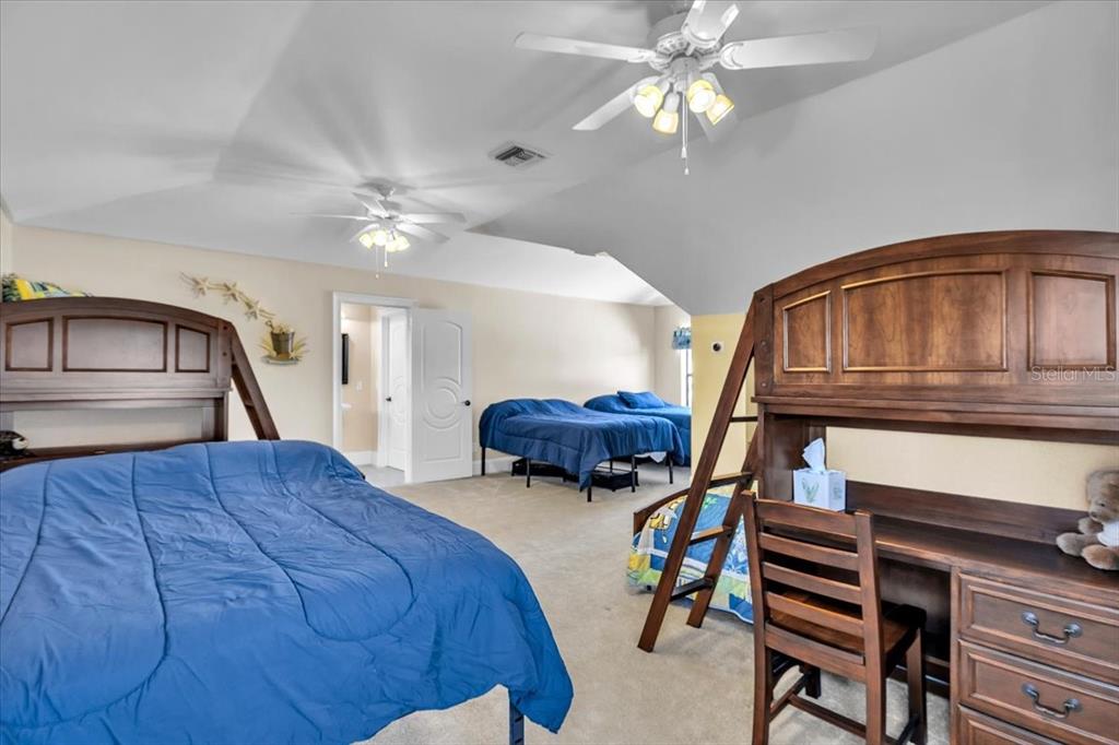 28959 Smugglers Lane Punta Gorda, FL 33982 - Photo 29 of 45 a bedroom with a bed and a chandelier