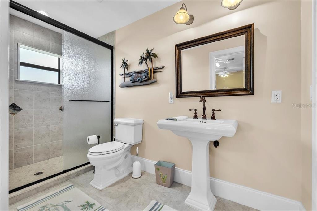 28959 Smugglers Lane Punta Gorda, FL 33982 - Photo 31 of 45 a bathroom with a toilet sink and mirror