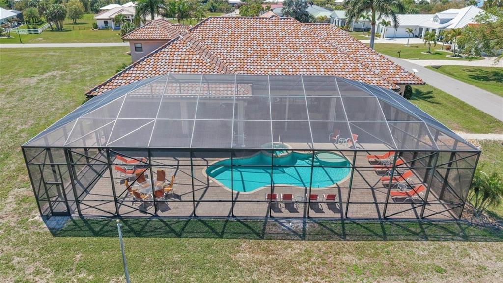 28959 Smugglers Lane Punta Gorda, FL 33982 - Photo 39 of 45 a view of a patio with a table and chairs under an umbrella