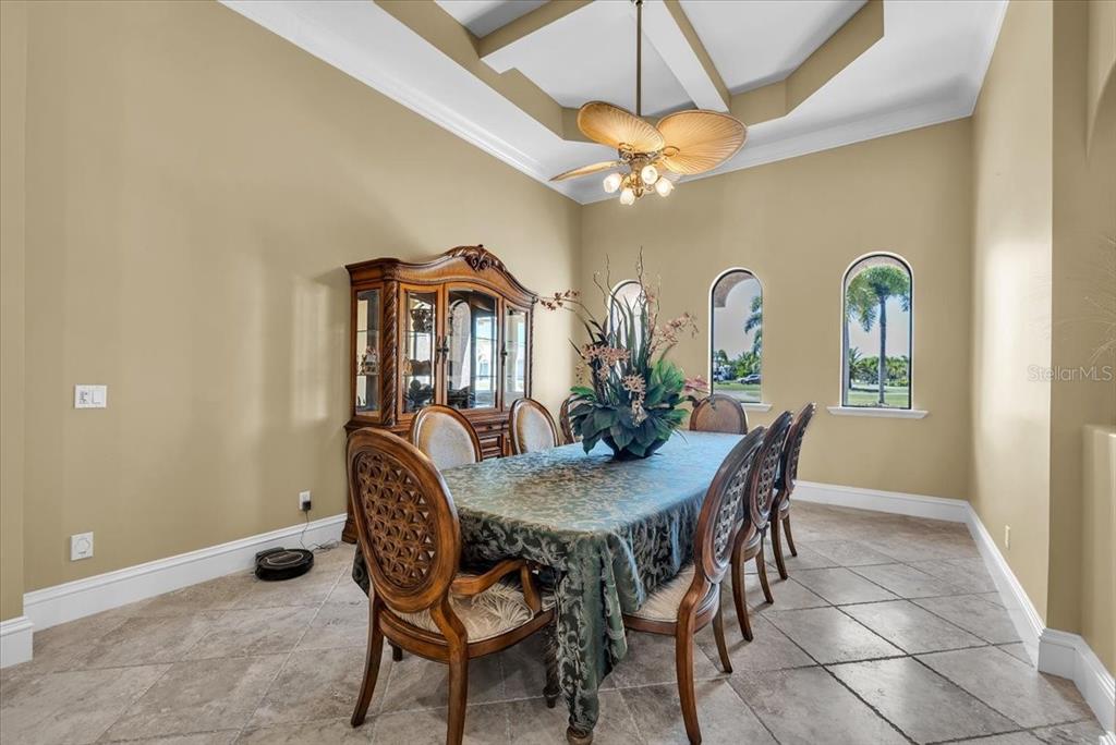 28959 Smugglers Lane Punta Gorda, FL 33982 - Photo 10 of 45 a view of a dining room with furniture and a chandelier fan
