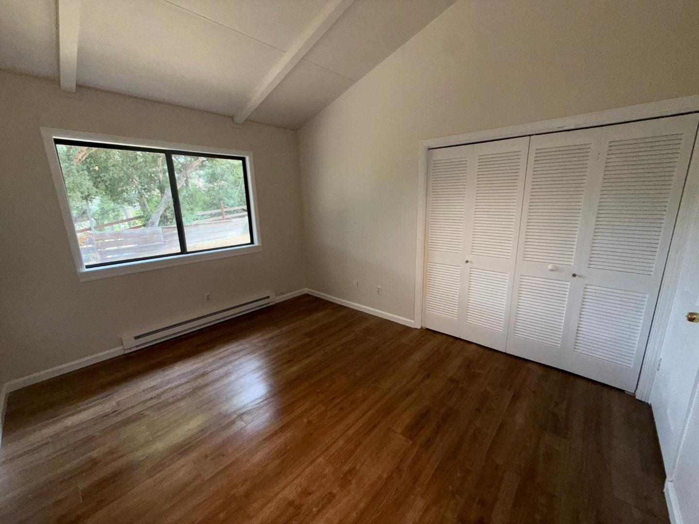 11585 McCarthy Road Carmel Valley, CA 93924 - Photo 35 of 52 a view of an empty room with wooden floor and a window