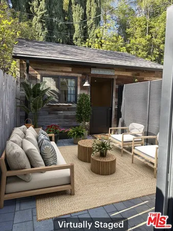 a view of patio with couches and a potted plant