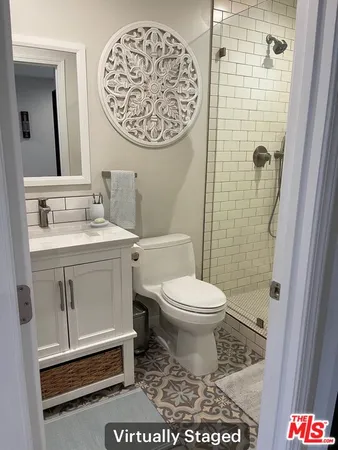 a bathroom with a shower toilet and sink