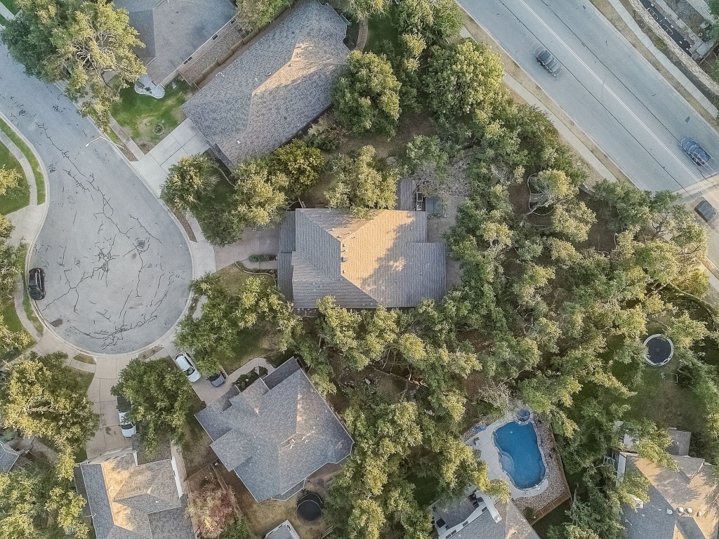 an aerial view of a house with outdoor space and a lake view