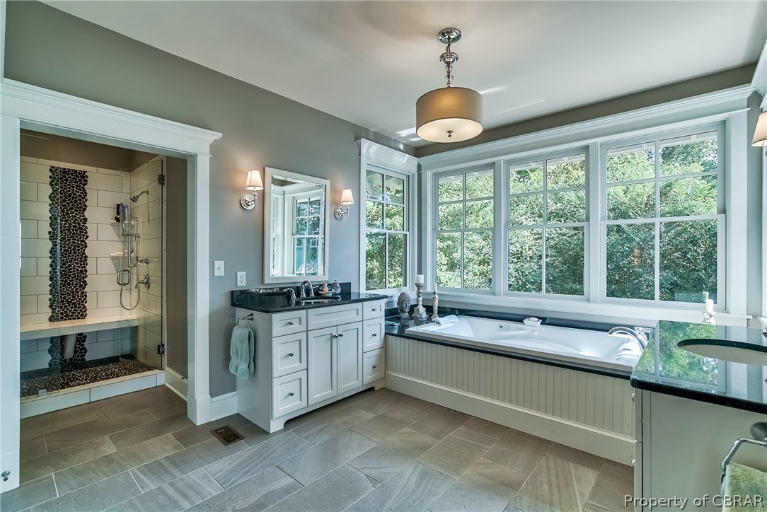 904 Queenstown Road Lancaster, VA 22503 - Photo 23 of 40 Master Bath: 11 x 13 tile flooring, his and hers 4? vanities plus separate make-up area, large 3.5 x 6 jacuzzi tub framed by walls of glass windows, large linen closet.
