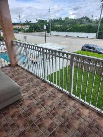 a view of a room with furniture and wooden floor