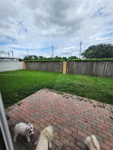 a view of yard with patio