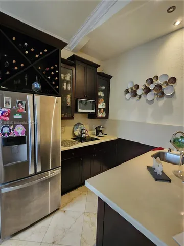 a kitchen with a sink a stove and cabinets