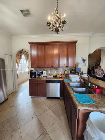 a kitchen with sink cabinets and window