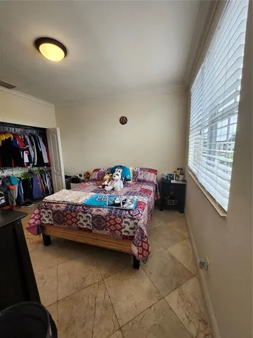 a view of a yard with large tree and wooden fence