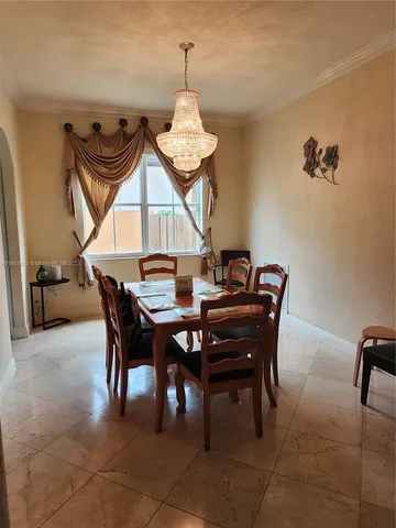 a living room with furniture chandelier and a chandelier