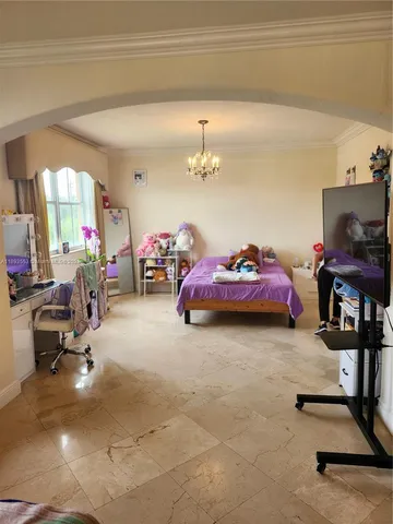 a room with painting on the wall and a window