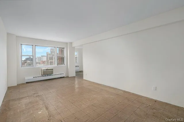 an empty room with large windows