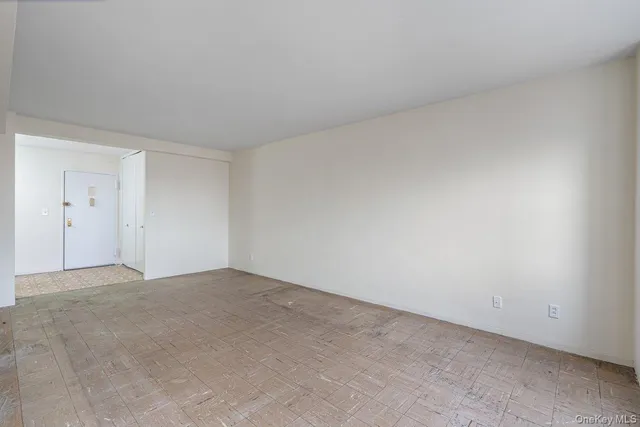 a view of an empty room and closet area