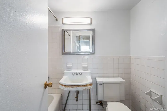 a view of a room with a chandelier fan