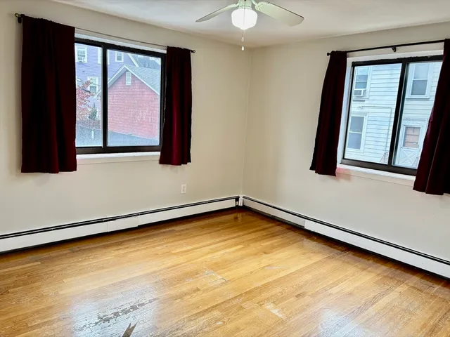 a view of a room with wooden floor and cabinet