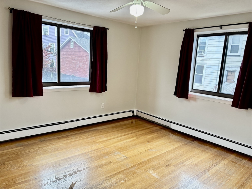 2192 Massachusetts Avenue, Unit 14 Cambridge, MA 02140 - Photo 11 of 19 a view of a room with wooden floor and cabinet