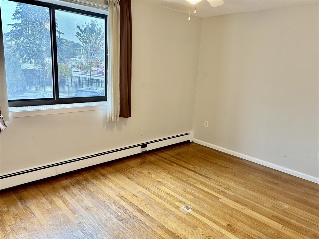 2192 Massachusetts Avenue, Unit 14 Cambridge, MA 02140 - Photo 16 of 19 a view of a room with wooden floor and doors