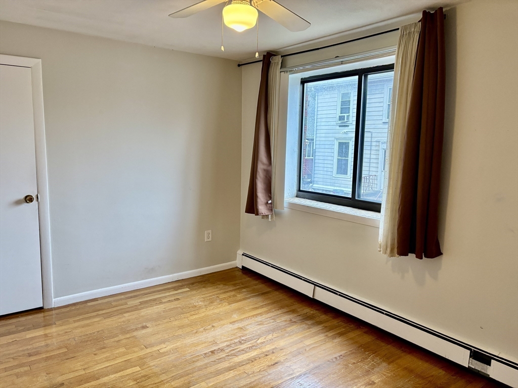 2192 Massachusetts Avenue, Unit 14 Cambridge, MA 02140 - Photo 17 of 19 a view of a room with wooden floor and window