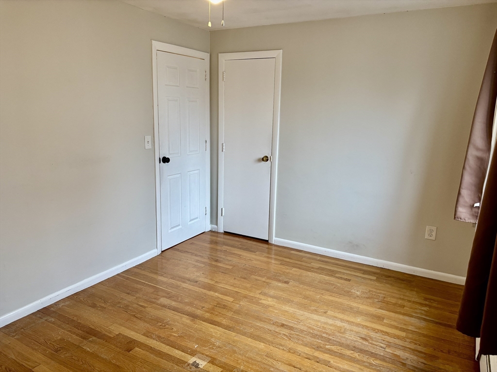 2192 Massachusetts Avenue, Unit 14 Cambridge, MA 02140 - Photo 18 of 19 a view of an empty room with wooden floor