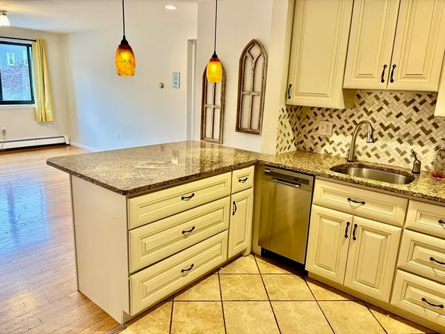 a view of a kitchen with counter top and appliances