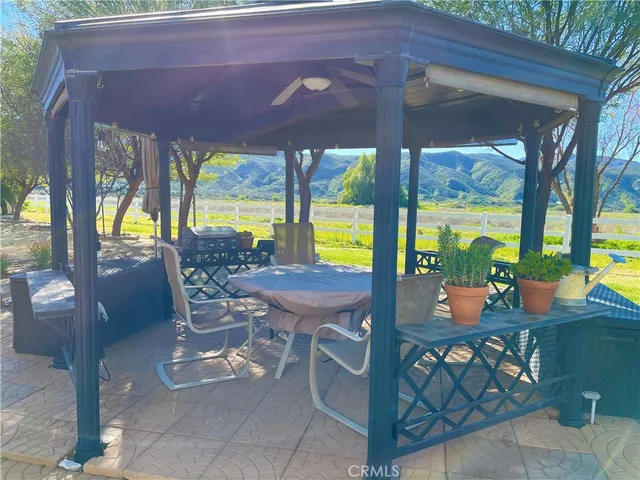 a view of a patio with a table and chairs