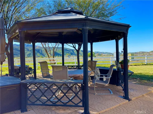 a view of a patio with a table chairs and a table