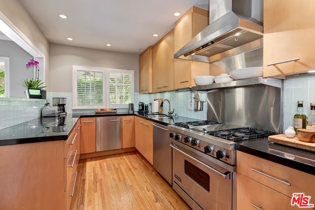 10629 Rountree Road Los Angeles, CA 90064 - Photo 13 of 37 a kitchen with stainless steel appliances granite countertop a stove a sink and a microwave