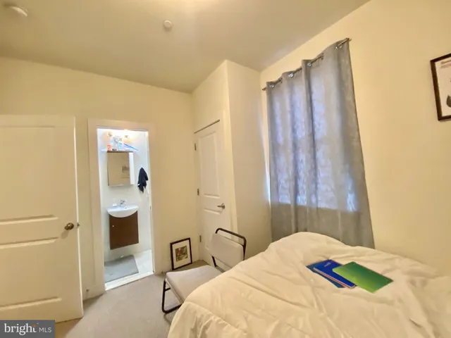 a bedroom with a bed and a table
