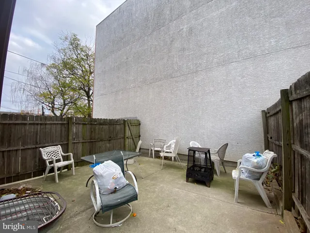 a building outdoor space with patio furniture and potted plants